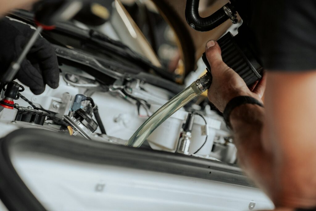 A mechanic working on a car's engine components during a vehicle repair